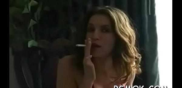  Alluring honey enjoys a relaxing cigarette by the window